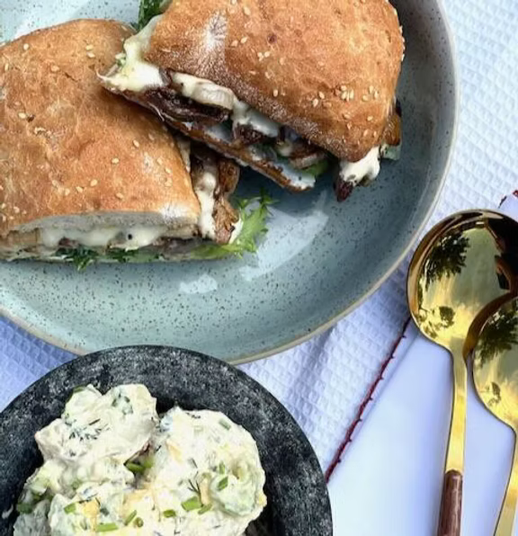 STEAK ROLL WITH MUSHROOMS, PROVOLONE CHEESE SERVED WITH A CANADIAN STYLE POTATO SALAD