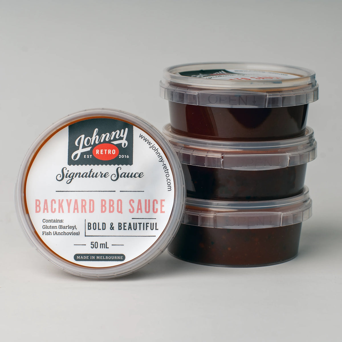 Johnny Retro Bold and Beautiful Backyard BBQ Sauce carton with 48 single-serve 50 mL containers